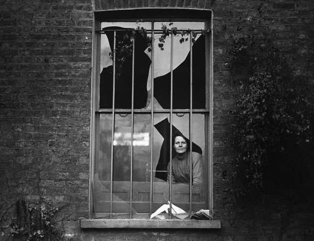 A suffragette looks through a window on Holloway prison