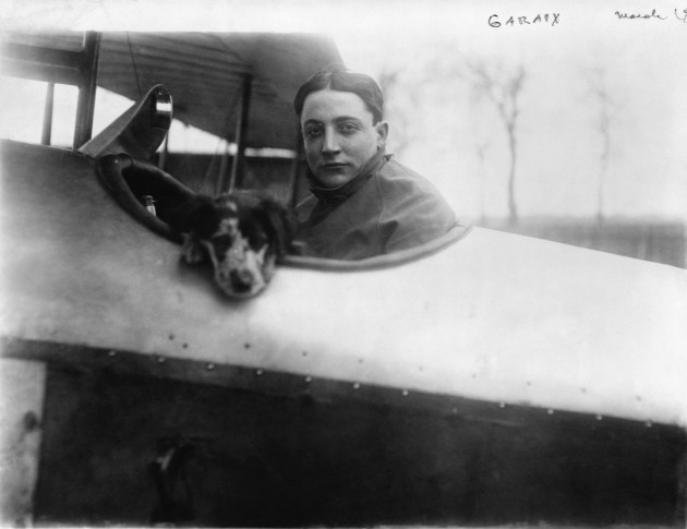 French pilot Roland Garros and dog in biplane