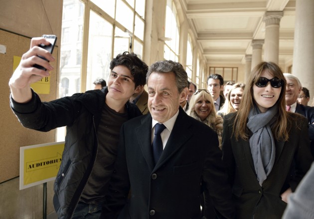 Young man takes a selfie with former President Nicolas Sarkozy and his wife Carla Bruni