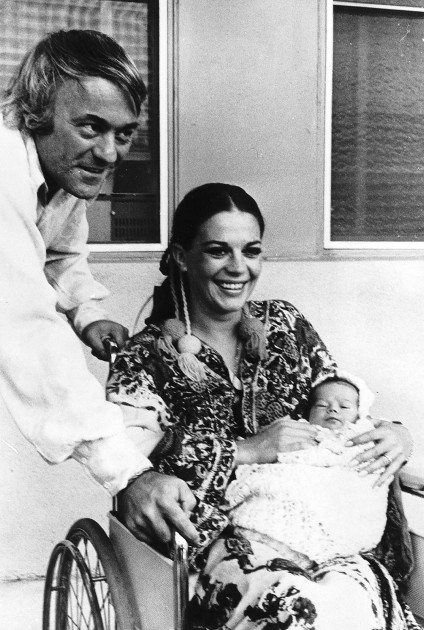Natalie Wood leaving hospital with her newly born daughter and husband Richard Gregson sitting in