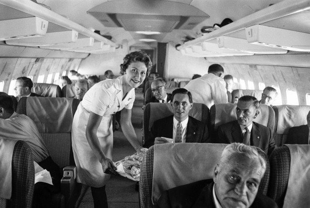 An air stewardess serving food to passengers on board a Qantas Boeing 707 plane at London airport.-7th August 1959.-5
