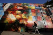A man walks past a mural of Nelson Mandela painted by Brazilian artist Eduardo Kobra in Los Angeles, California