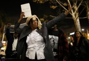 LadyBlue dances at a candlelight vigil in memoriam of Nelson Mandela s death, in Los Angeles, California