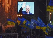 Nelson Mandela seen on a huge screen, as Ukrainians hold a moment of silence to honor his death during a pro-European Union rally, in the Independent Square in Kiev, Ukraine