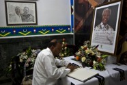 A man signs a Nelson Mandela condolence book inside the South African Embassy in Havana, Cuba