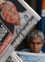 A Sri Lankan resident reads a newspaper carrying the image of South African former president Nelson Mandela and news of his death in Colombo