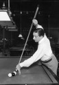 Billiard player setting up to take shot