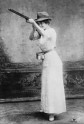 Woman posed with shotgun for trapshooting