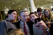 Norway’s former Prime Minister Jens Stoltenberg poses for a selfie with youngsters