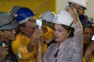 Workers take pictures of Brazilian President Dilma Rousseff