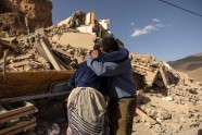 Family members react near the rubble of collapsed buildings in the village of Imi N Tala near Amizmiz in central Morocco after the deadly 6.8-magnitude September 8 earthquake, on September 10, 2023