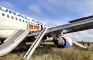 A handout still image taken from a handout video made available by the Russian Emergencies Ministry press-service shows an Airbus A320 Ural Airlines plane on the field after an emergency landing due to critical engine failure and hydraulic failure, at a site in the Ubinsky district, Novosibirsk region, Russia, 12 September 2023