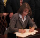 Judy Garber signing papers